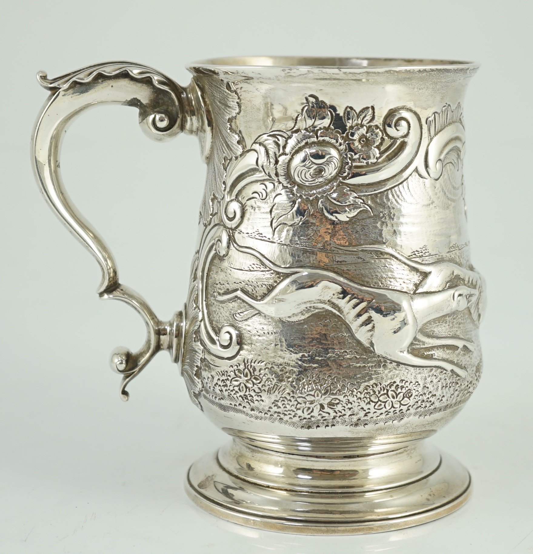 A George III silver baluster mug, later embossed with continuous hare coursing scene, John Scofield